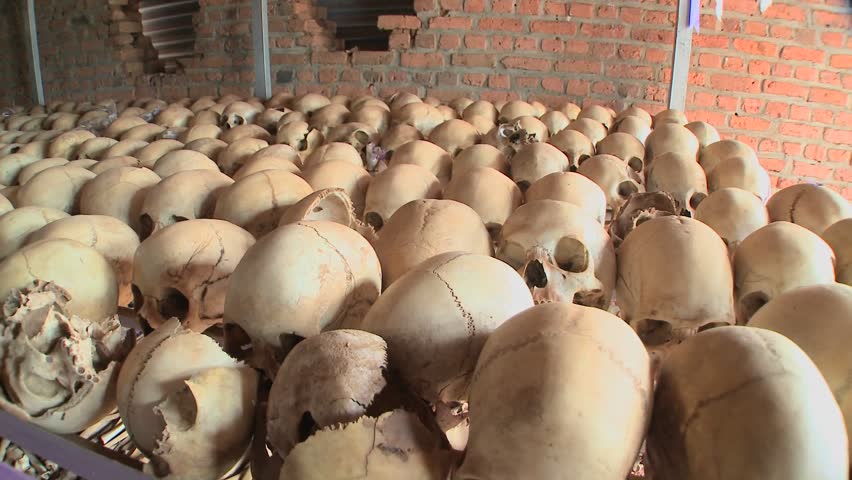 Slow pan across hundreds of skulls in a display in a church remembering the Rwandan holocaust.