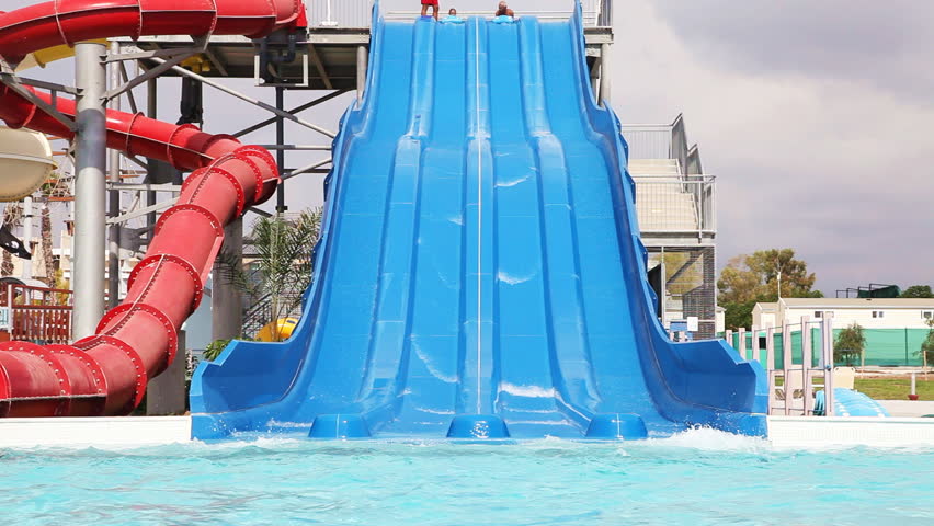 Sliding down on water slide in waterpark 