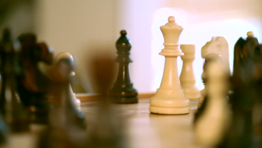 The white queen takes a black castle in the game of chess.