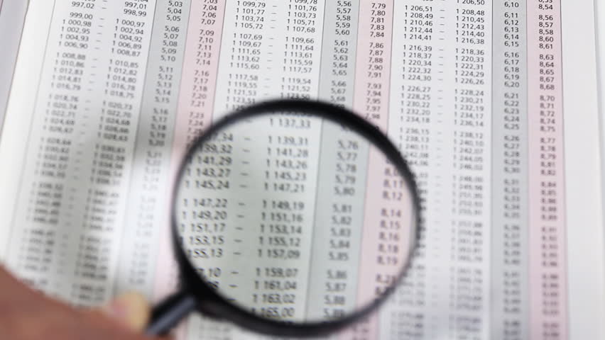 Accounting. Business woman with magnifying glass working with documents.  