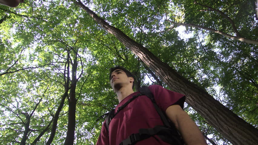 birdwatching with young man and woman using binoculars and looking for birds in forest