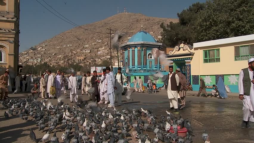 KABUL, AFGHANISTAN - CIRCA 2009: Pigeons fly in front of the Shah-e Do Shamshera Mosque circa 2009 in Kabul, Afghanistan. Afghanistan is an impoverished and least developed country, one of the world's poorest. 
