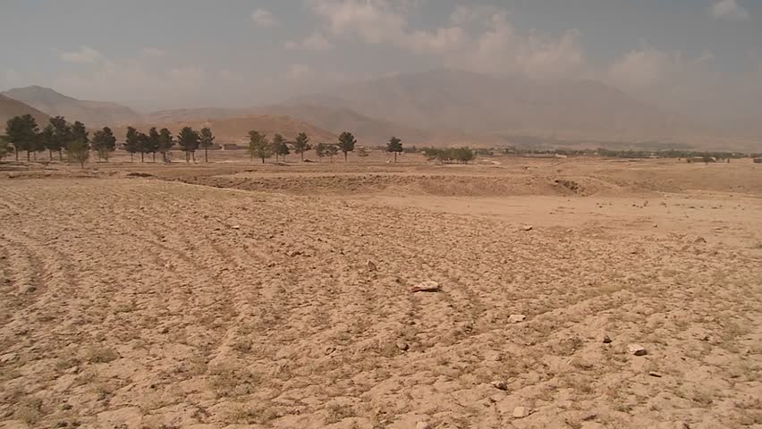 KABUL, AFGHANISTAN - CIRCA 2009: Pan of landmine field to ANA soldier outside circa 2009 in Kabul, Afghanistan. Afghanistan is an impoverished and least developed country, one of the world's poorest.