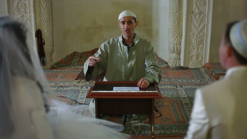 Imam (islamic priest) preaching at the Wedding Ceremony Nikah of Crimean Tatars in Mosque. Bakhchisaray Palace (Hansaray, Khan's Palace) Bakhchisaray, Crimea, Ukraine.