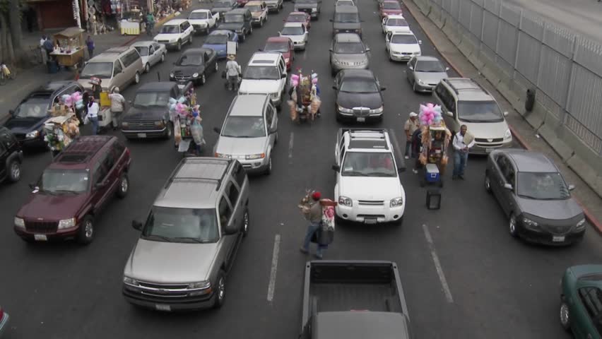 Vendors hock their goods as cars wait to cross back into the United States from Tijuana.