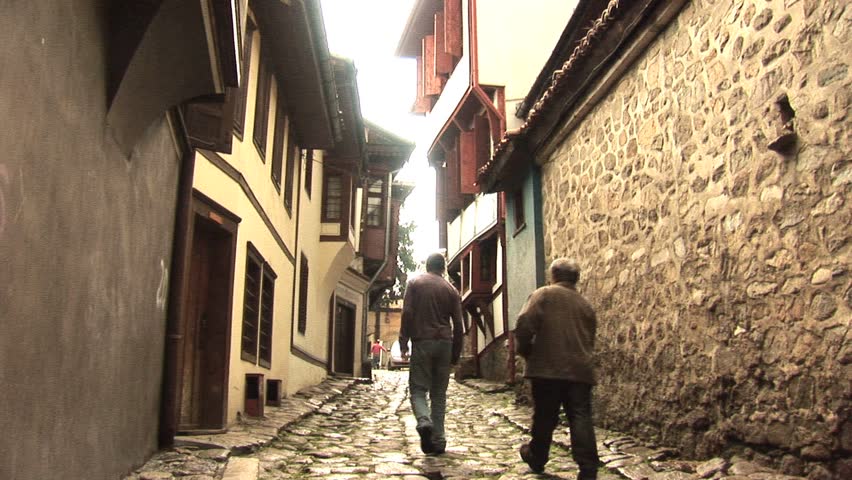 Two people walking on a cobble stone street circa 2010 in Plovdiv, Bulgaria