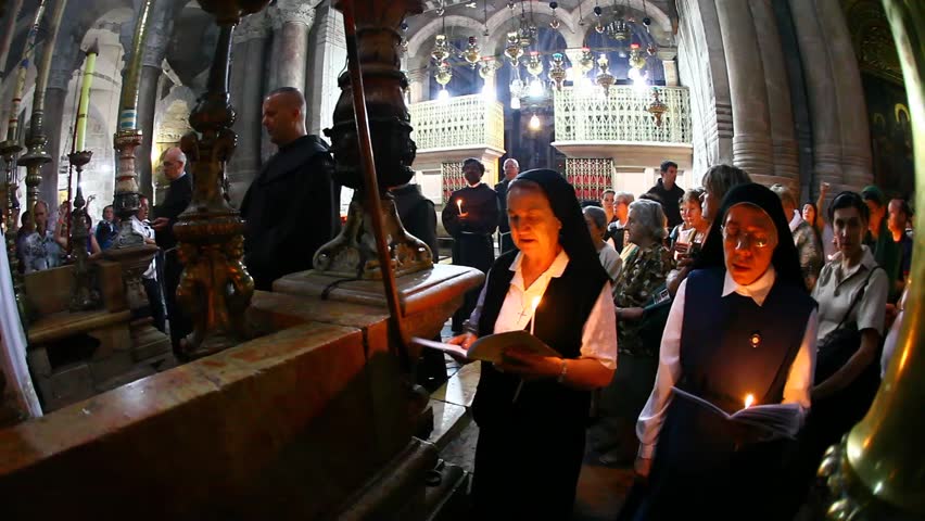 JERUSALEM - OCTOBER 04: Christian pilgrims pray with priests and nuns during mass in the Church of the Holy Sepulchre during visit to the holyland October 04 2011 in Old City Jerusalem, Israel.
