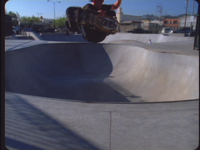 VENTURA, CA - CIRCA 2006: A boy in a city park makes a fancy jump with his skateboard circa 2006 in Ventura. The Pacific skatepark is one of three free parks in Ventura - the rest of the family includes Ventura's West and Hobart skateparks.