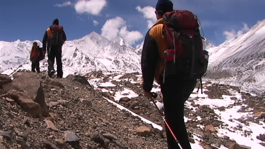 Climbers walk into panoramic Himalayan background