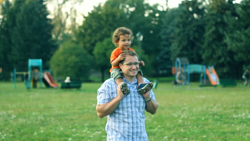 Father giving son piggyback ride in the park