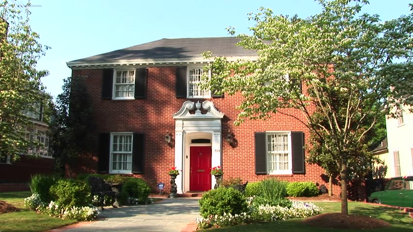 Colonial revival home with bright red door