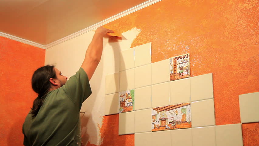 Master applies colored wax on ornamental plaster. 