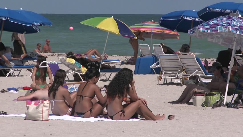 MIAMI, FL - CIRCA 2009: Three women lay out on South Beach, circa 2009 in Miami. South Beach iis ranked tenth in Florida locations by per capita income.