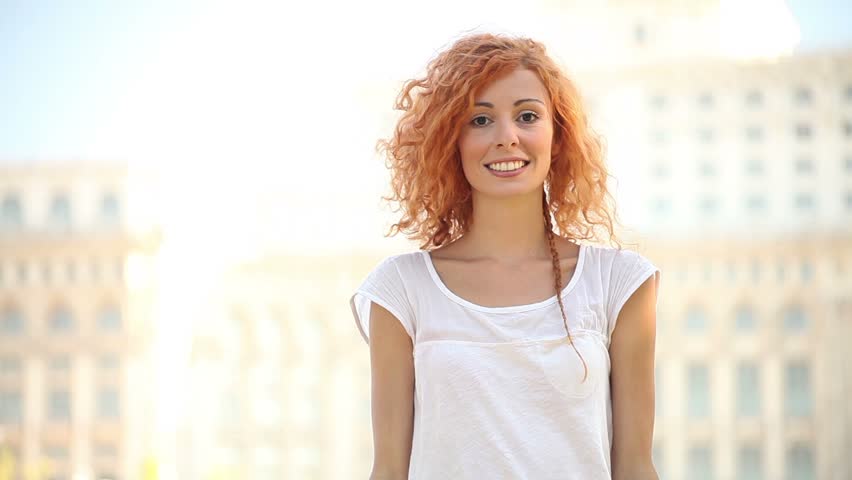 Excited adult pretty young woman air quotes and smiles. 