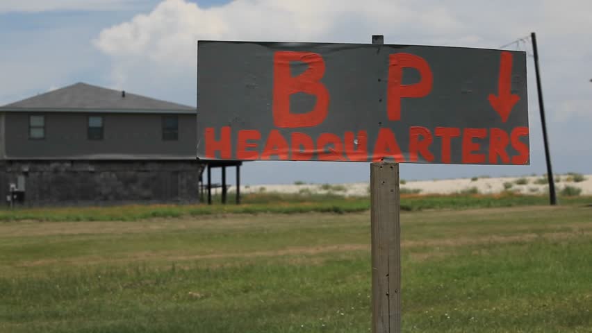 A makeshift sign identifies the headquarters of BP during the oil spill disaster as the camera pans down to a toilet
