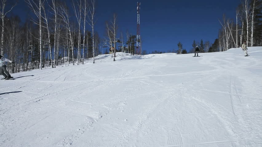 Snowboarder outrunning his friends on a winding ride