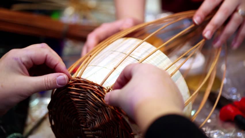 Process of basket braiding lesson, only hands visible