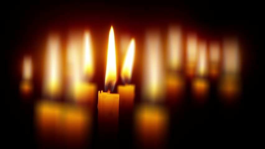 many candles with shallow depth - religious theme on black wide perspective 