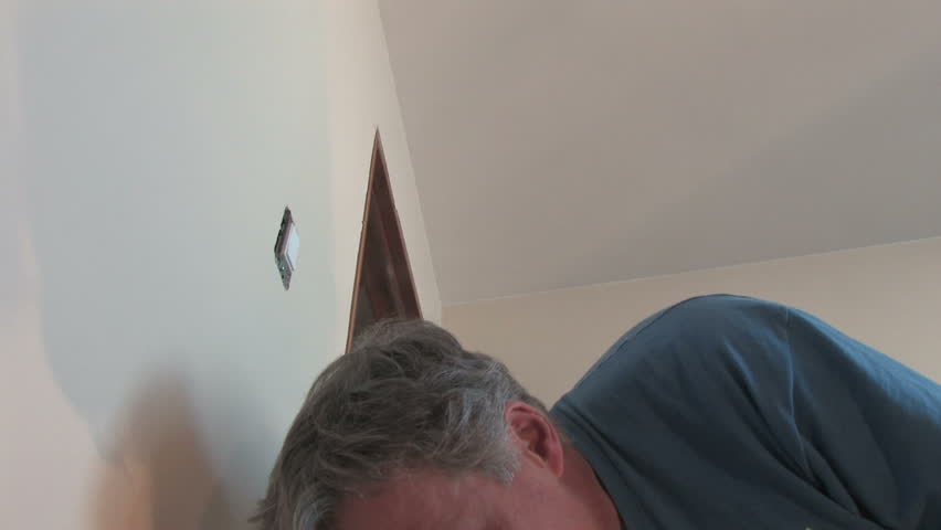 Man installs a light switch.