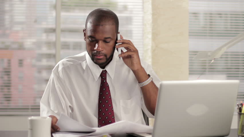 Business man talking on the phone in his office