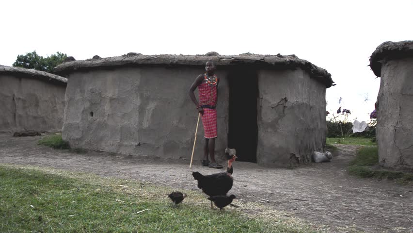 MASAI MARA, KENYA - OCTOBER 17: A young Masaai experiences daily life in his village on October 17, 2011 in Masai Mara, Kenya. The Maasai are a Nilotic ethnic group of semi-nomadic people located in Kenya and northern Tanzania. 