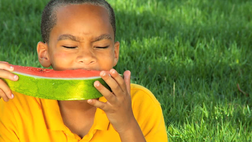 Young Ethnic Boy Eating Refreshing Water Melon