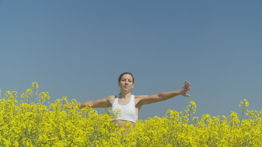 happy woman pivoting in rape field