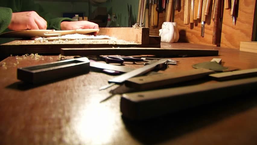 Hands perform carpentry at his place with the help of a tool.