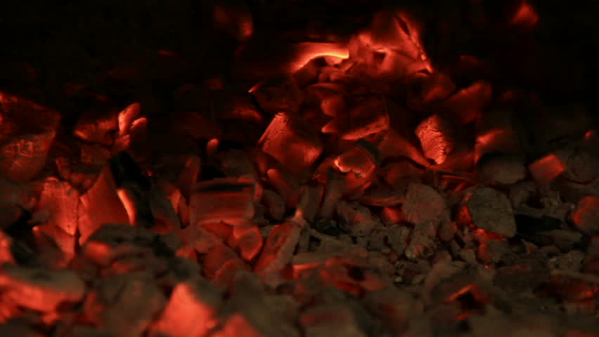 Metal poker knead hot coals up sparkles