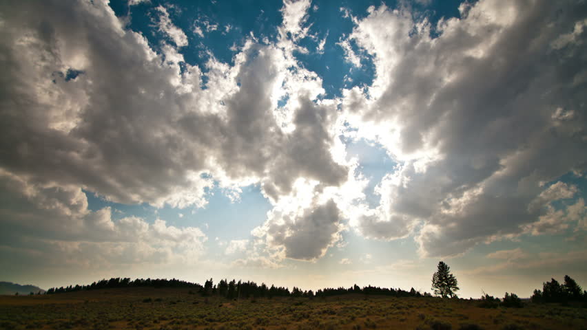 Time lapse over Montana field with sunbeams