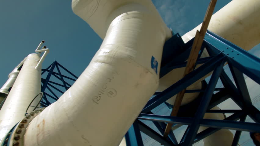 Slider dolly move along jungle gym of huge white water desalination pipes at the IDE Ashkelon desalination plant in Israel.