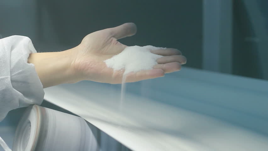 White sugar manufacturing. Workers hand holding crystal sugar in the sugar refinery. HD 1080i