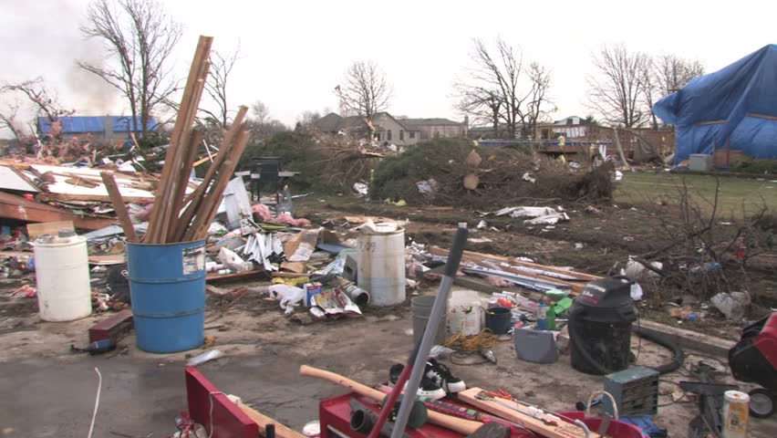 Panning across the wreckage of a house, destroyed by a tornado. 