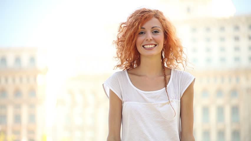 Excited adult pretty young woman air quotes and smiles. 