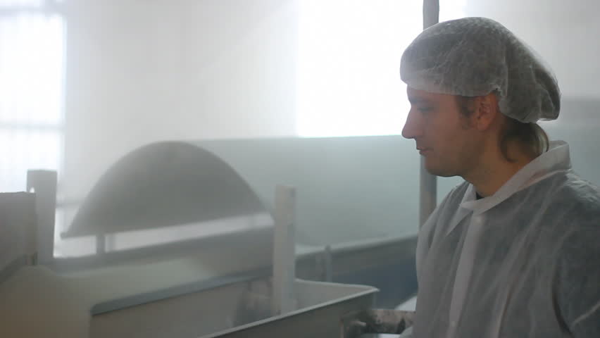 Worker controls quality of sugar in a Factory 