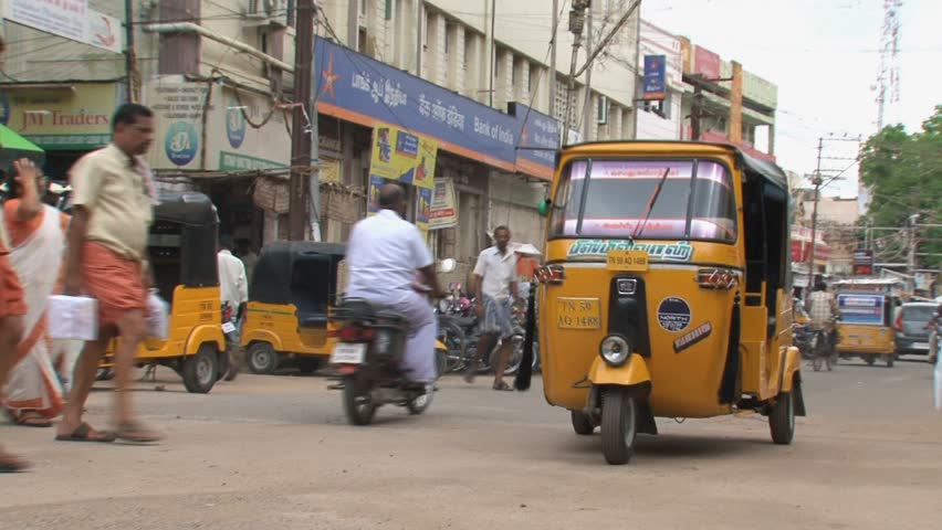 INDIA - CIRCA APRIL, 2011:  Busy Indian street with rickshaws and motorbikes.