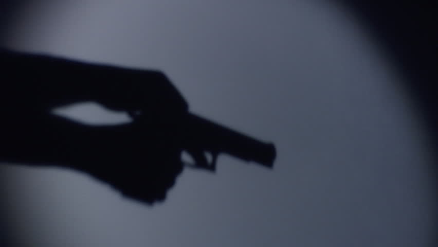 silhouette of a guy loading a gun