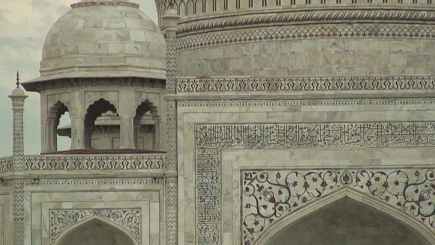 AGRA, INDIA - AUGUST 16, 2006: Zoom out from the white marble dome of the Taj Mahal in Agra, India
