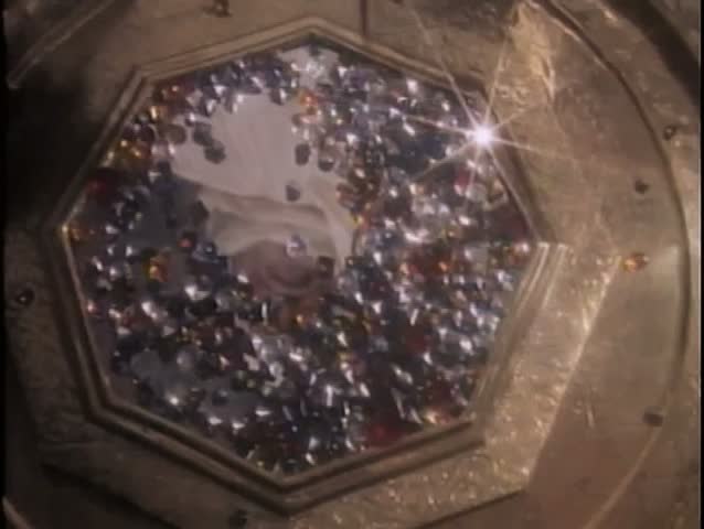 Multicolored gems pouring from bag