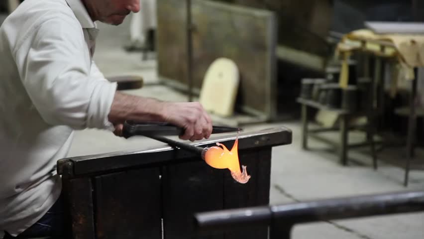 VENICE - JANUARY 4: Glass blower crafts a glass horse, January 4, 2012 in Murano, Venice. Venetian glass is a type of glass object made in Venice, Italy, primarily on the island of Murano. It is world-renowned for being colourful, elaborate, and skillfull