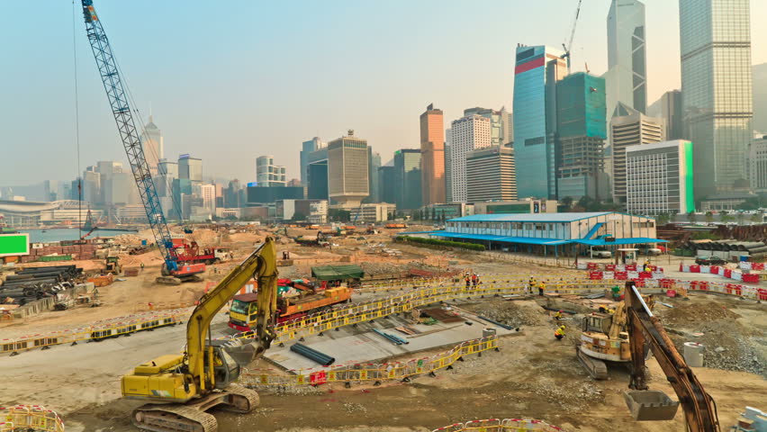 Operation of construction equipment during putting up skyscraper on the background of a megacity Hong Kong, timelapse