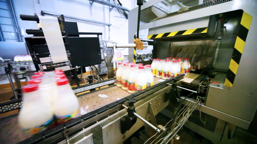 packets bottles of milk go belt conveyor and automation pastes to back side sticker