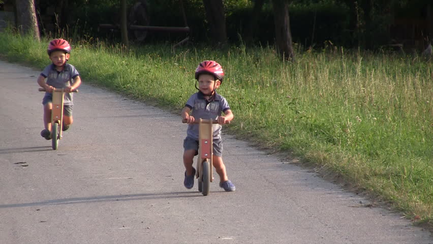 Boys on wooden bicycles