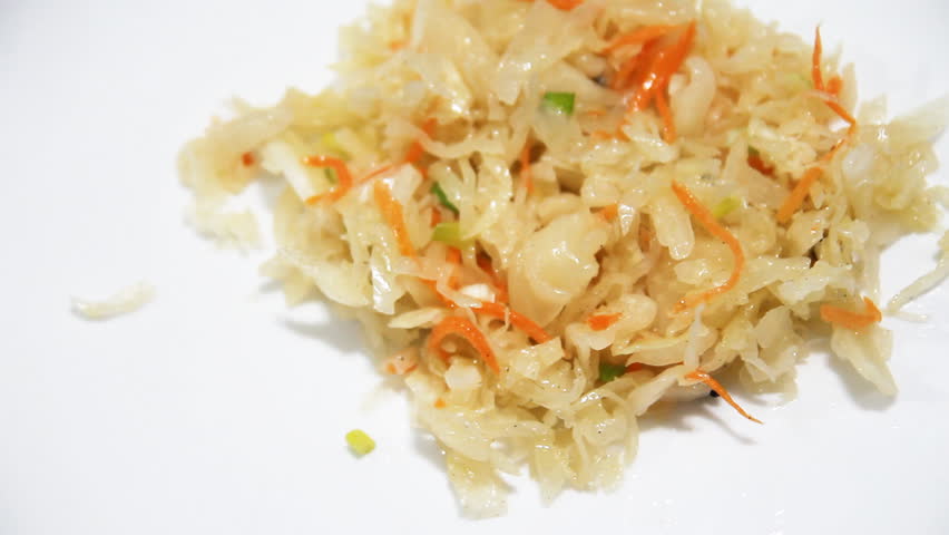 sauerkraut mixed with a fork on a white background