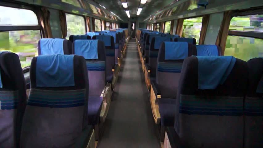 Interior of moving train with outside view from inside