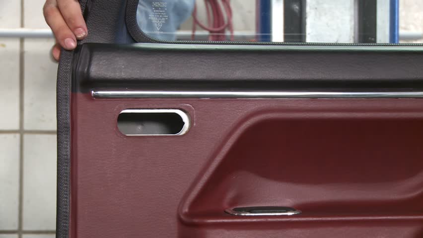 Mechanic removing car door shell