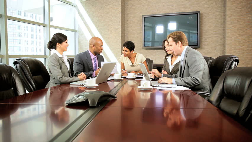 Female african american executive in a boardroom meeting with her multi ethnic business team