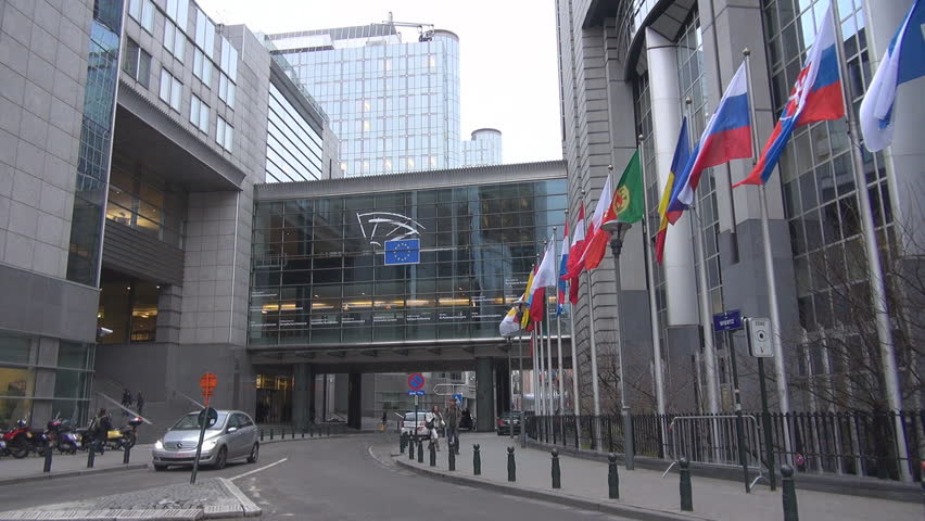 BRUSSELS, BELGIUM - DECEMBER 19 2011: Unidentified people and cars pass near to European Parliament 
