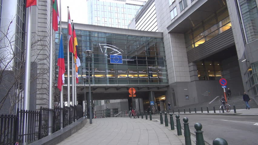 BRUSSELS, BELGIUM - DECEMBER 19 2011: Unidentified people and cars pass near to European Parliament 