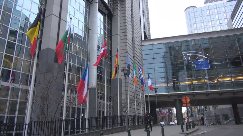 BRUSSELS, BELGIUM - DECEMBER 19 2011: Unidentified people and cars pass near to European Parliament 